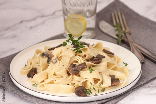 Pasta with mushrooms herbs and creamy sauce