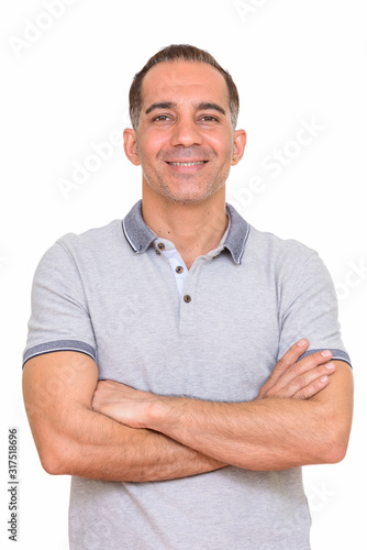 Mature happy Persian man smiling with arms crossed