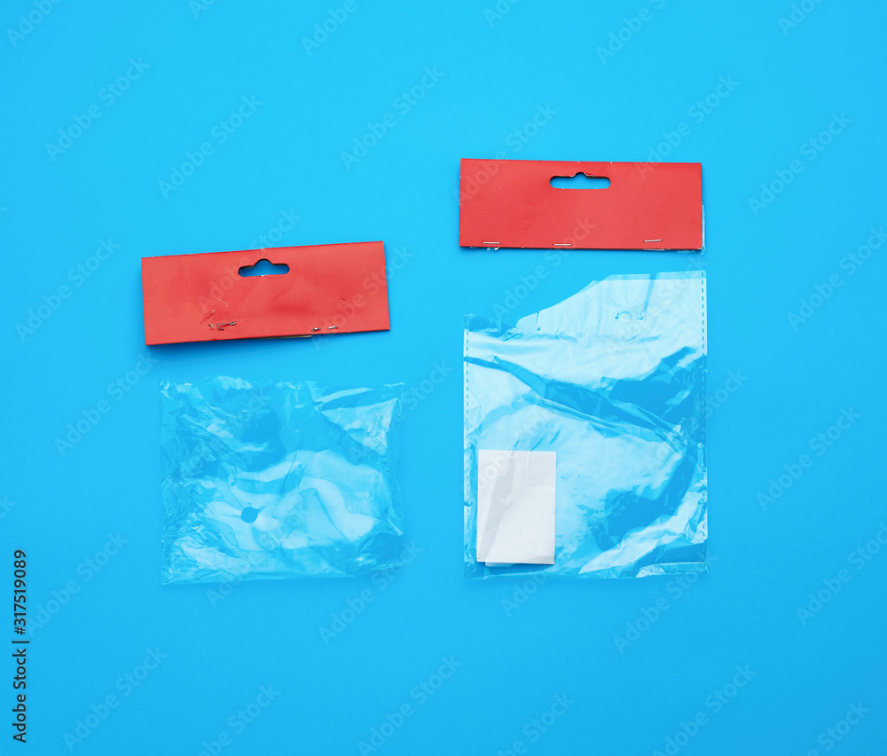 two transparent torn plastic bags with paper red top for packaging goods two transparent torn plastic bags with paper red top for packaging goods