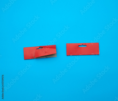 two red cardboard pieces of paper on a blue background