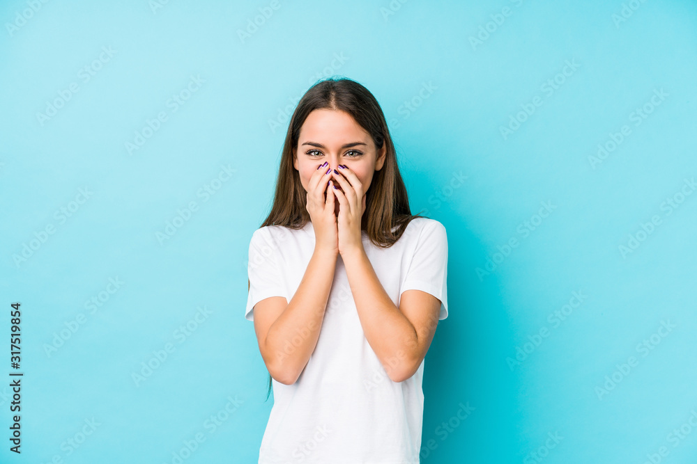 Young caucasian woman isolated laughing about something, covering mouth with hands. Young caucasian woman isolated laughing about something, covering mouth with hands.