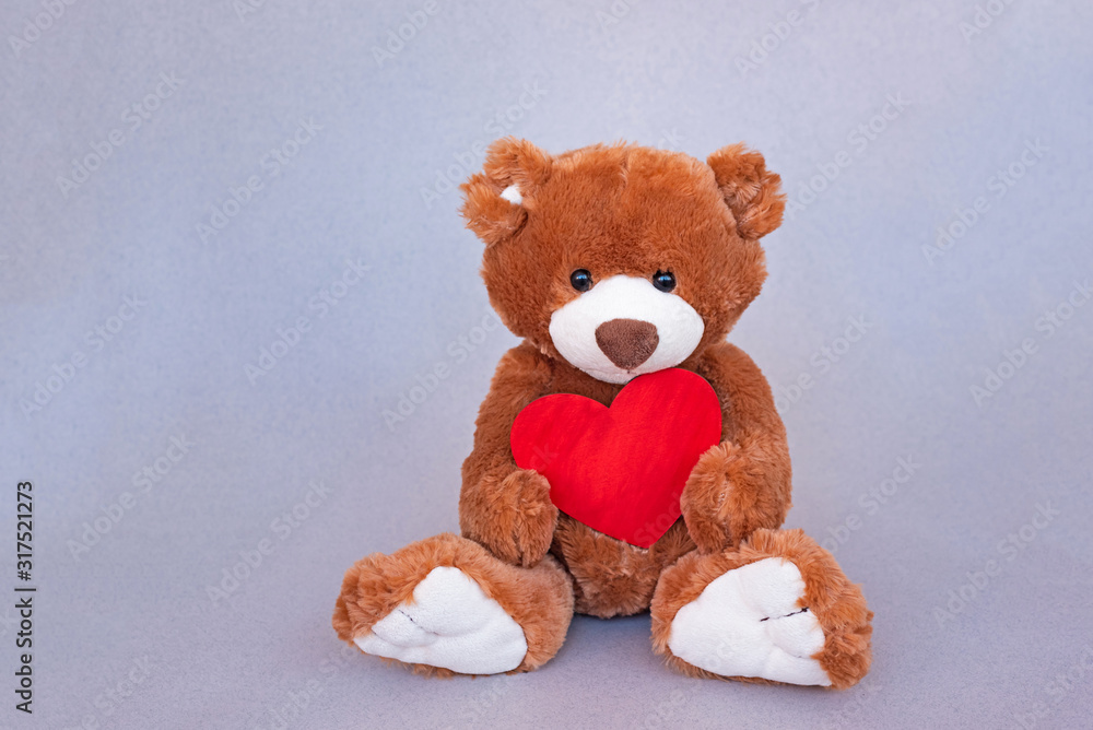 Valentines Teddy Bear holding wooden red heart