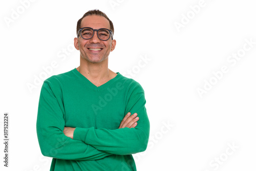 Mature happy Persian man with arms crossed