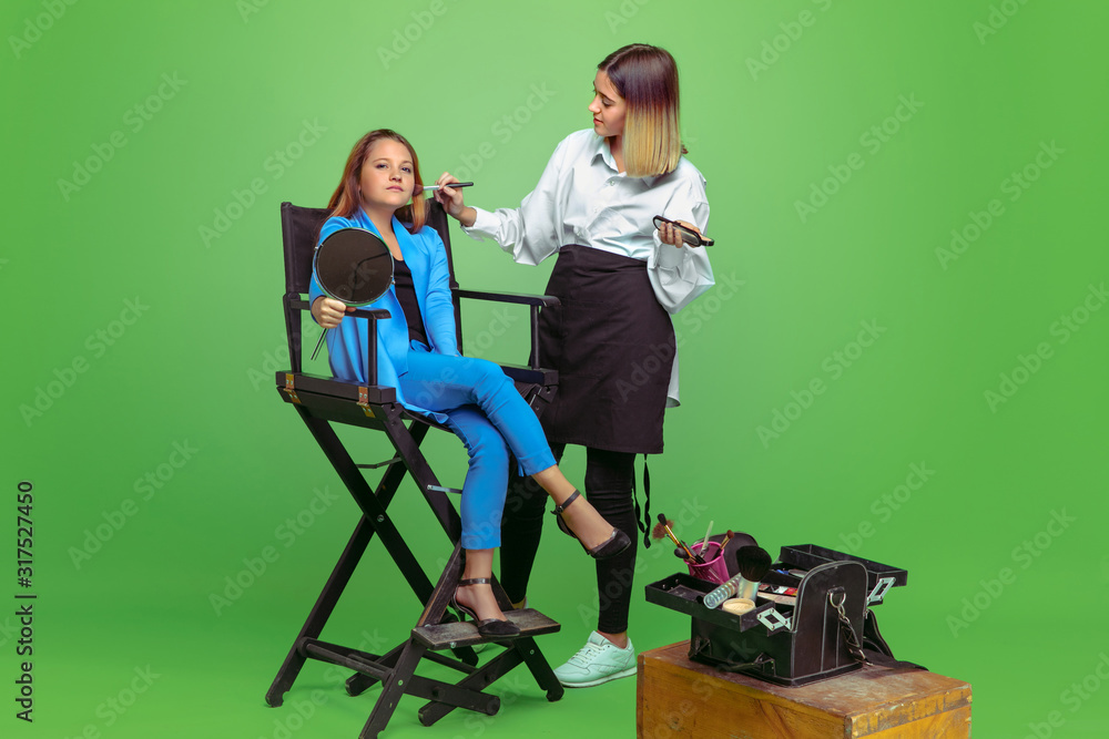Obraz premium First client. Little girl dreaming about profession of make up artist. Childhood, planning, education, dream concept. Wants to become successful employee in fashion and style industry, visage artist.