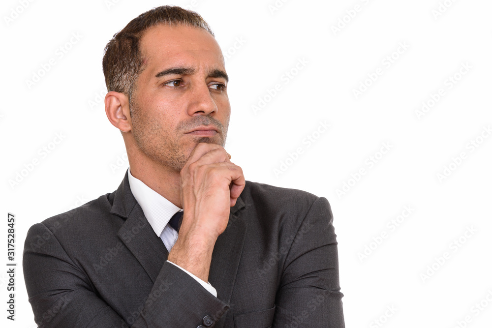 Face of mature handsome Persian businessman in suit thinking Face of mature handsome Persian businessman in suit thinking