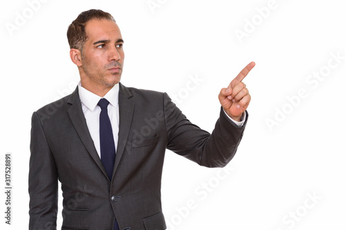 Mature handsome Persian businessman in suit pointing finger