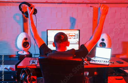 Sound engineer working and mixing music indoors in the studio photo