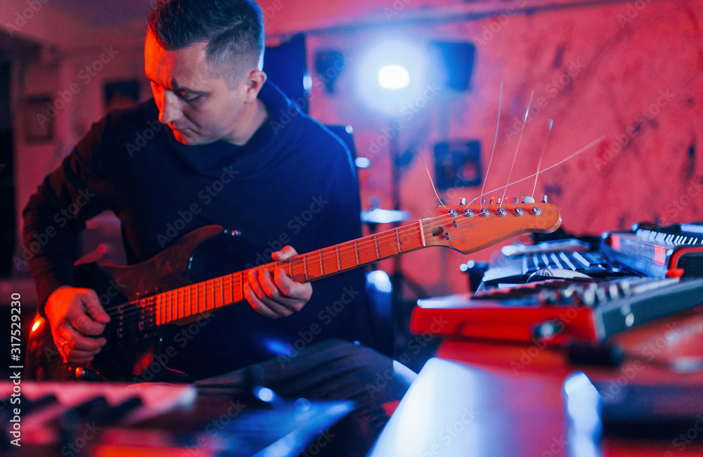 Obraz premium Guitar player have recording session indoors in the studio