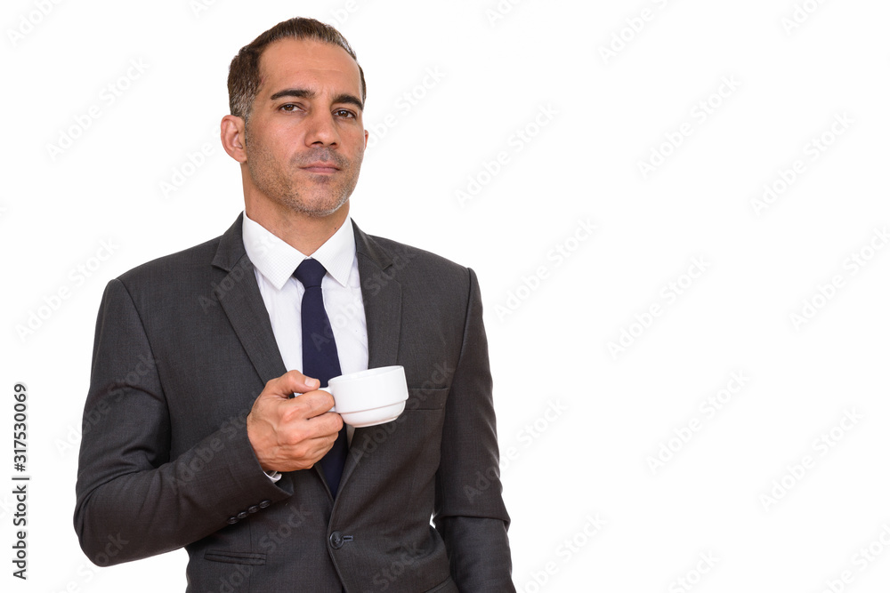 Mature handsome Persian businessman holding coffee cup Mature handsome Persian businessman holding coffee cup