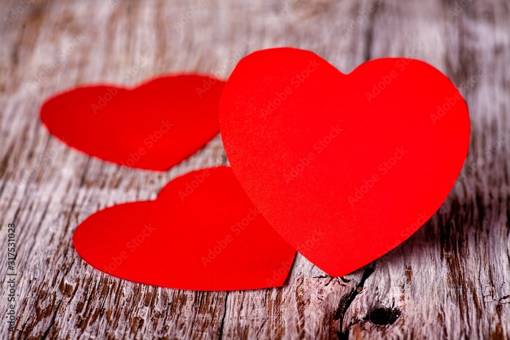 Red paper hearts on a wooden background. Holidays. Valentine's Day. Red paper hearts on a wooden background. Holidays. Valentine's Day.