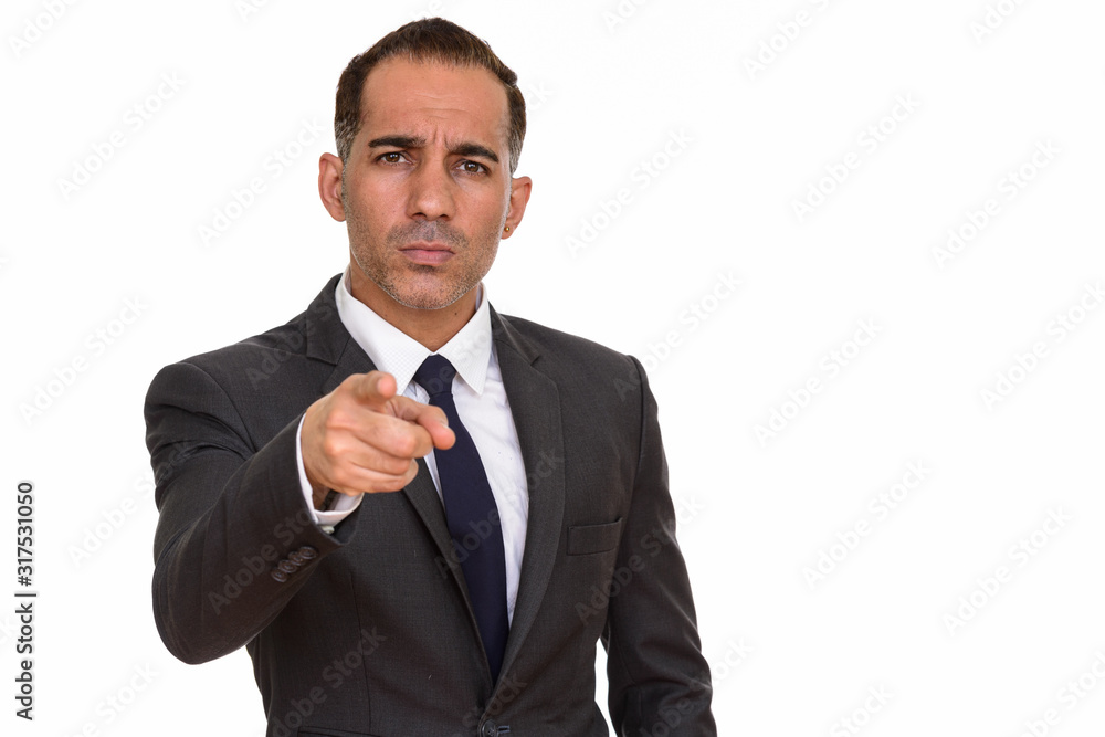 Mature handsome Persian businessman pointing finger at camera Mature handsome Persian businessman pointing finger at camera