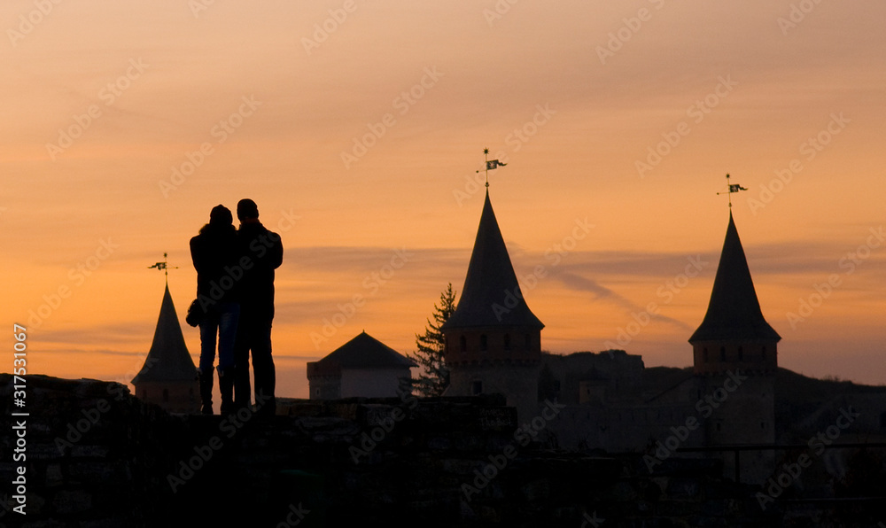 Kamianets-Podilskyi: couple in love at sunset Kamianets-Podilskyi: couple in love at sunset