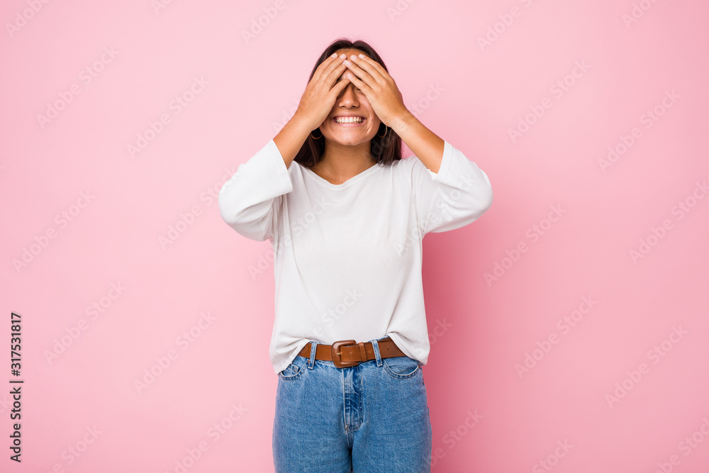 Young mixed race indian woman covers eyes with hands, smiles broadly waiting for a surprise. Young mixed race indian woman covers eyes with hands, smiles broadly waiting for a surprise.