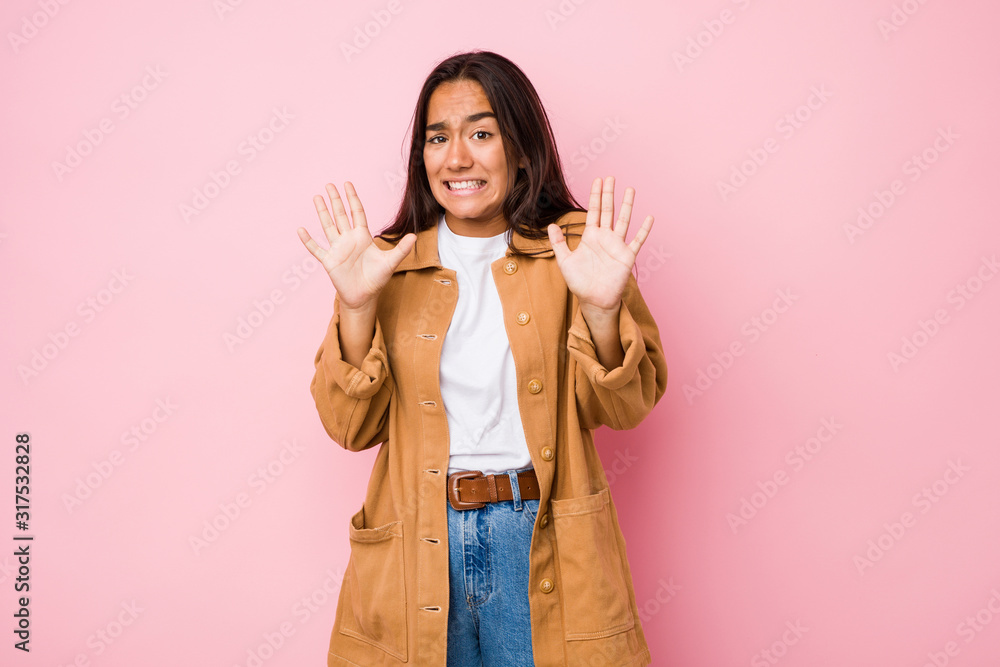 Young mixed race indian woman isolated rejecting someone showing a gesture of disgust. Young mixed race indian woman isolated rejecting someone showing a gesture of disgust.