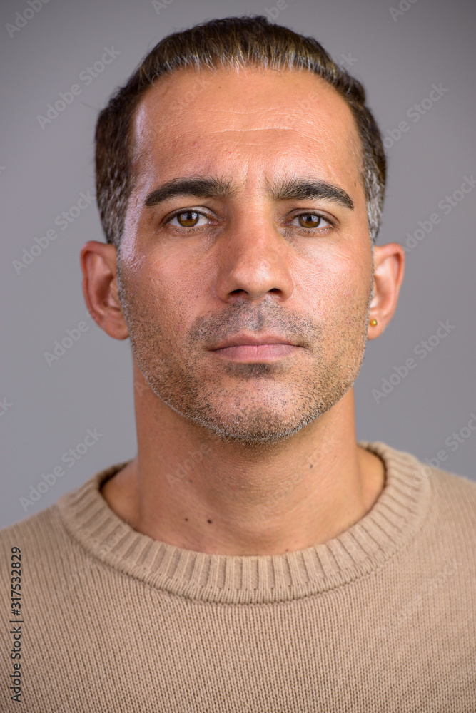 Face of mature handsome Persian man looking at camera Face of mature handsome Persian man looking at camera