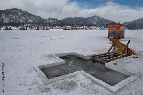 Russia. Mountain Altai near the village of Artybash. Epiphany bathing is a folk tradition that exists in Russia, associated with dipping or bathing on January 19 on the Orthodox feast of the Epiphany  photo