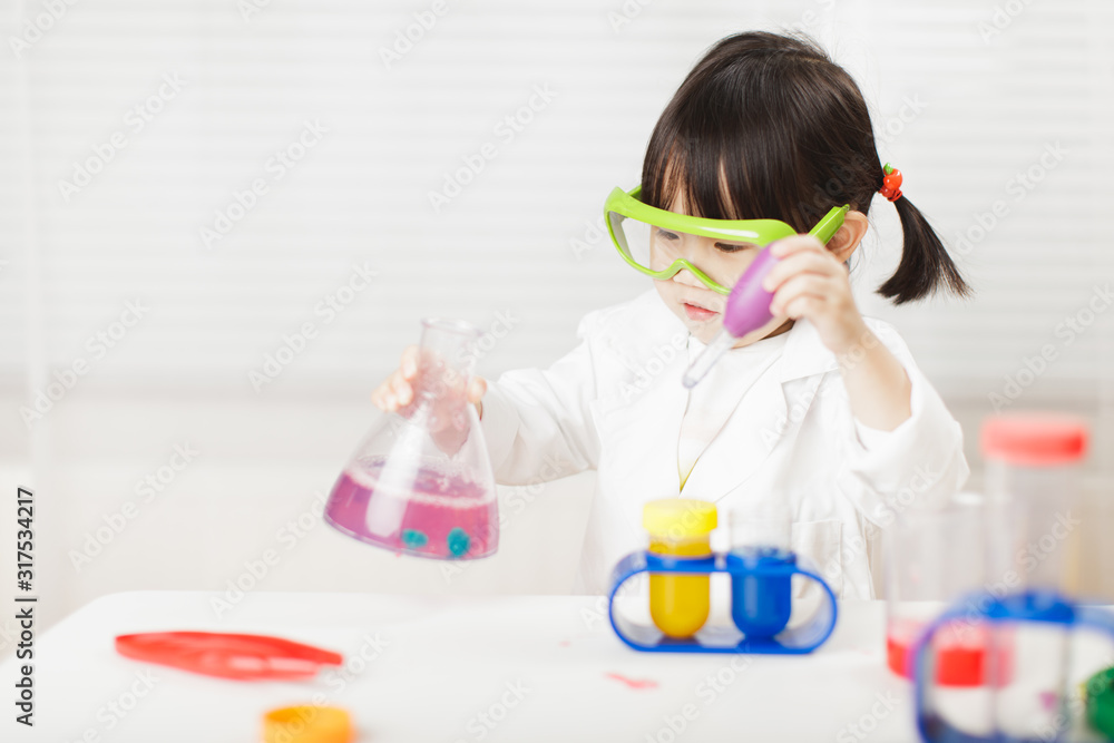 toddler girl pretend play scientist role at home against white background toddler girl pretend play scientist role at home against white background