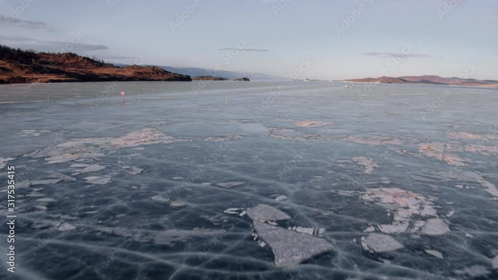 Frozen Lake Baikal winter landscape with clear smooth ice, Aerial view. Frozen Lake Baikal winter landscape with clear smooth ice, Aerial view.