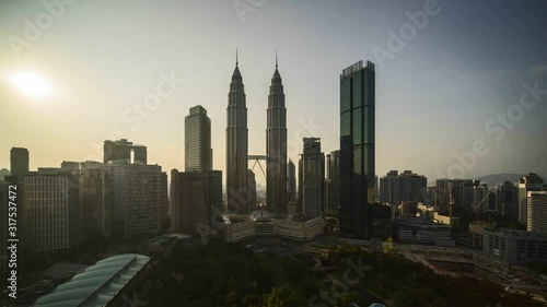 Kuala Lumpur, Malaysia - August 31, 2019: 4k time lapse of sunset over the horizon of Kuala Lumpur capital city centre, Petronas Twin Towers KLCC. 