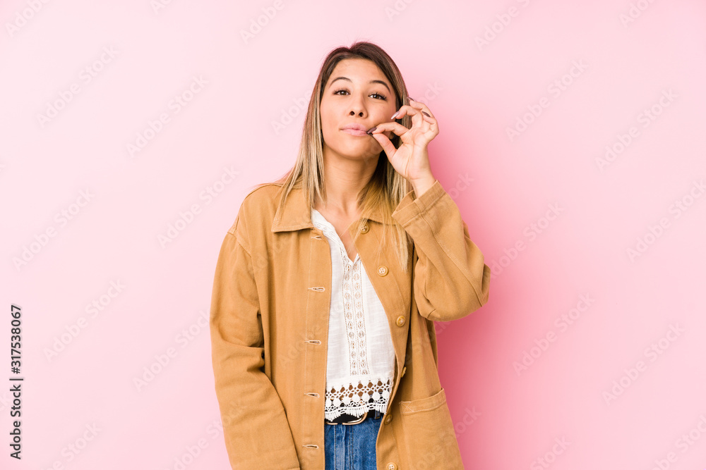 young caucasian woman posing isolated with fingers on lips keeping a secret. young caucasian woman posing isolated with fingers on lips keeping a secret.