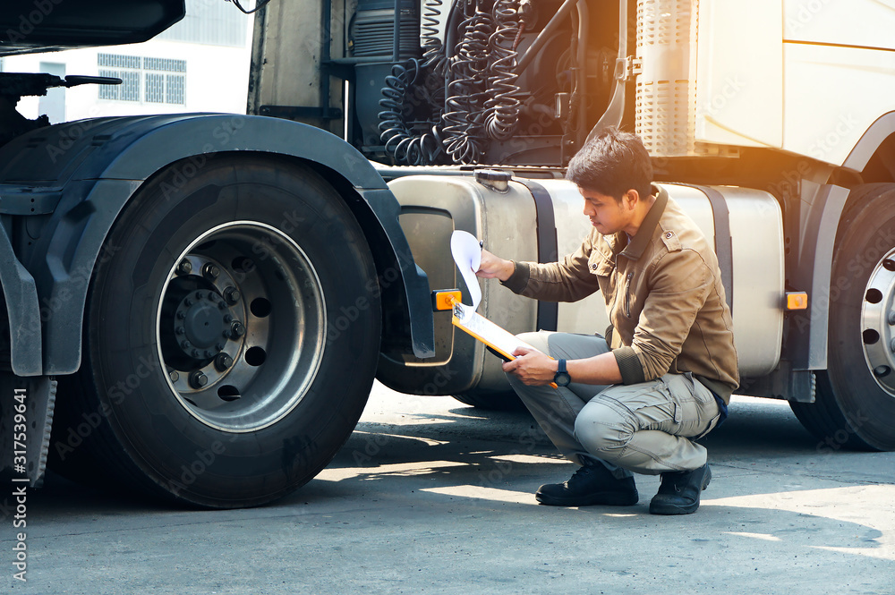 Asian Truck Drivers is Checking the Truck's Safety Maintenance