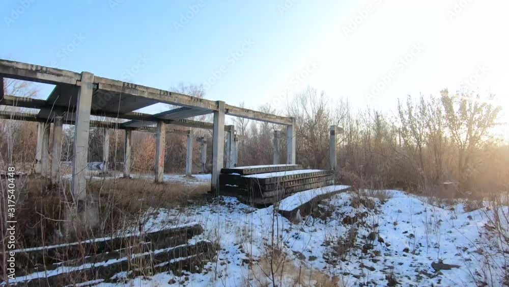 FPV drone flies quickly and maneuverable through an abandoned construction at sunset FPV drone flies quickly and maneuverable through an abandoned construction at sunset