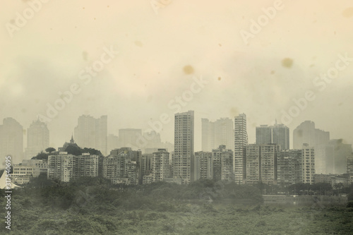 Cityscape of old urban building in Asia with bad air quality, covered by dust particles ,PM2.5,haze,fog,smog at sunset 