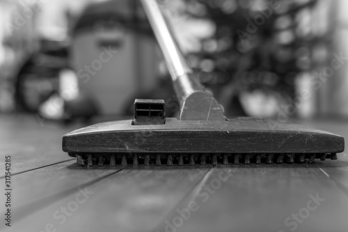 Wallpaper Mural Industrial vacuum cleaners brush on cracked dusty wooden floor, shallow depth of field, copy space, monochrome image. Torontodigital.ca