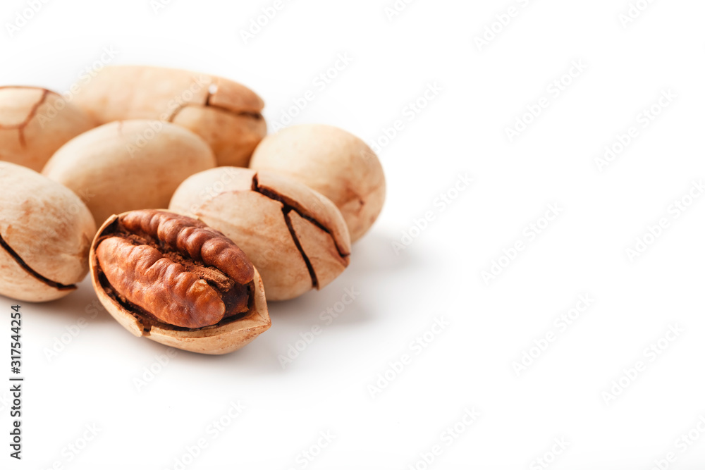 Pecan isolated on white background. Close-up, macro. A nut in a shell. Pecan isolated on white background. Close-up, macro. A nut in a shell.