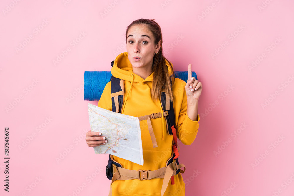 Young traveler caucasian woman isolated having some great idea, concept of creativity. Young traveler caucasian woman isolated having some great idea, concept of creativity.