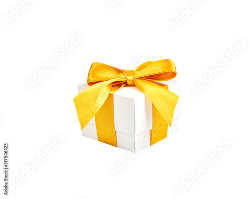 Handmade white paper box with yellow gold satin ribbon and bow on an isolated white background. © Evgeniy
