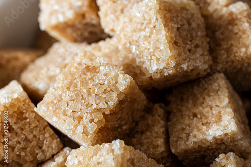 Pile of Golden Brown Sugar Cubes in Close Up