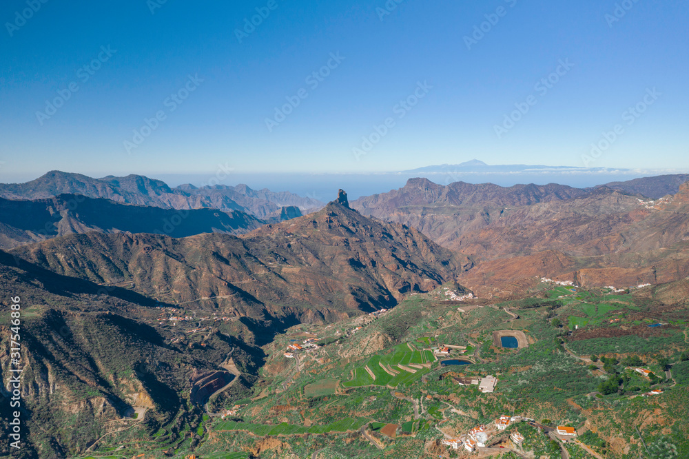 Scenic cinematic aerial view of Pico de las Nieves - the highest peak on the island of Gran Canaria on Canary Islands in Spain. Beautiful summer sunny look of mountains of islands in Athlantic ocean Scenic cinematic aerial view of Pico de las Nieves - the highest peak on the island of Gran Canaria on Canary Islands in Spain. Beautiful summer sunny look of mountains of islands in Athlantic ocean