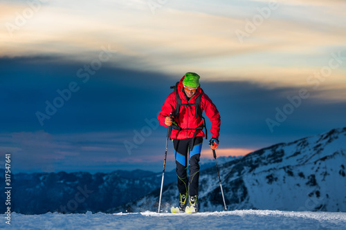 Ski touring at night in the last hours of the day