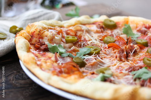 Italian cuisine. Pizza on a wooden background, rustic style