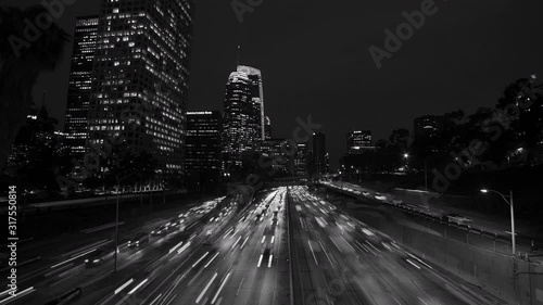 Timelapse of  California 110 South leads to downtown Los Angeles with streaked car lights at sunset photo