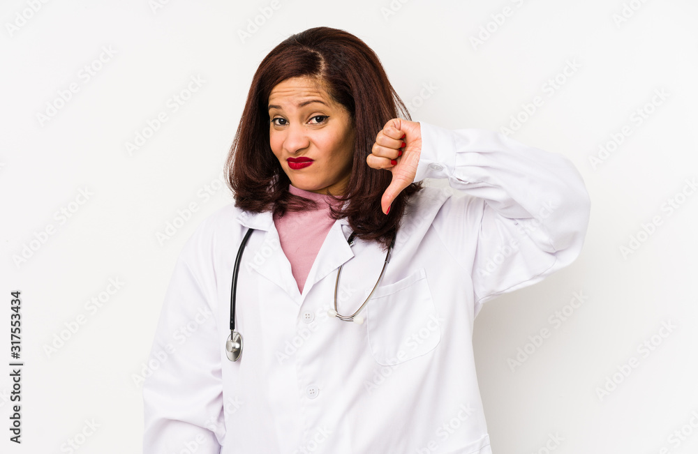 Middle age latin doctor woman isolated showing a dislike gesture, thumbs down. Disagreement concept. Middle age latin doctor woman isolated showing a dislike gesture, thumbs down. Disagreement concept.