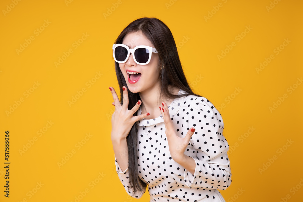 Fototapeta premium Asian woman in summer casual clothes.She smiling and happy shopping bags. she lovely attractive shine on yellow background.Summer Surprise Sale concept.