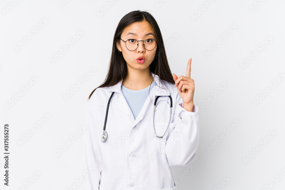 Young doctor chinese woman isolated having some great idea, concept of creativity. Young doctor chinese woman isolated having some great idea, concept of creativity.