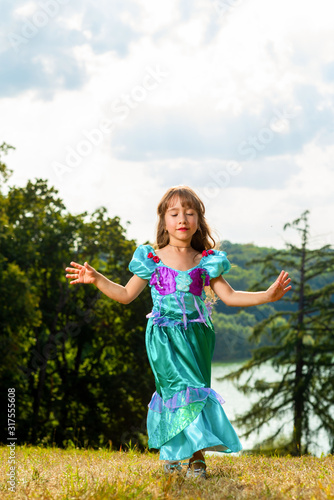 Girl in a princess dress in nature..