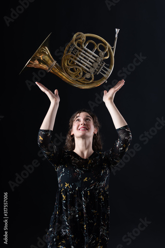 Porträt einer jungen Hornistin eines Philharmonischen Orchesters mit ihrem Instrument