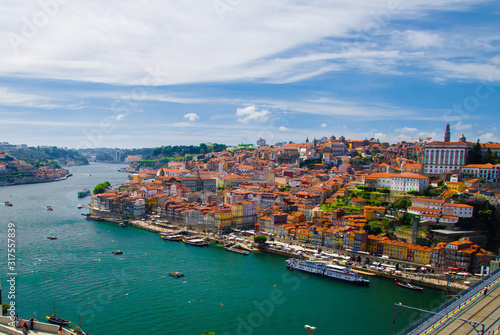 Portugal, Douro river, wonderful panoramic view of Porto, tourist centre of Porto, clear sunny day in Porto, light white clouds over Porto, colorful houses with red roofs in Porto