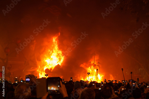 Monument burning at Fallas parties in Valencia, Spain. Start burning while viewers take pictures.