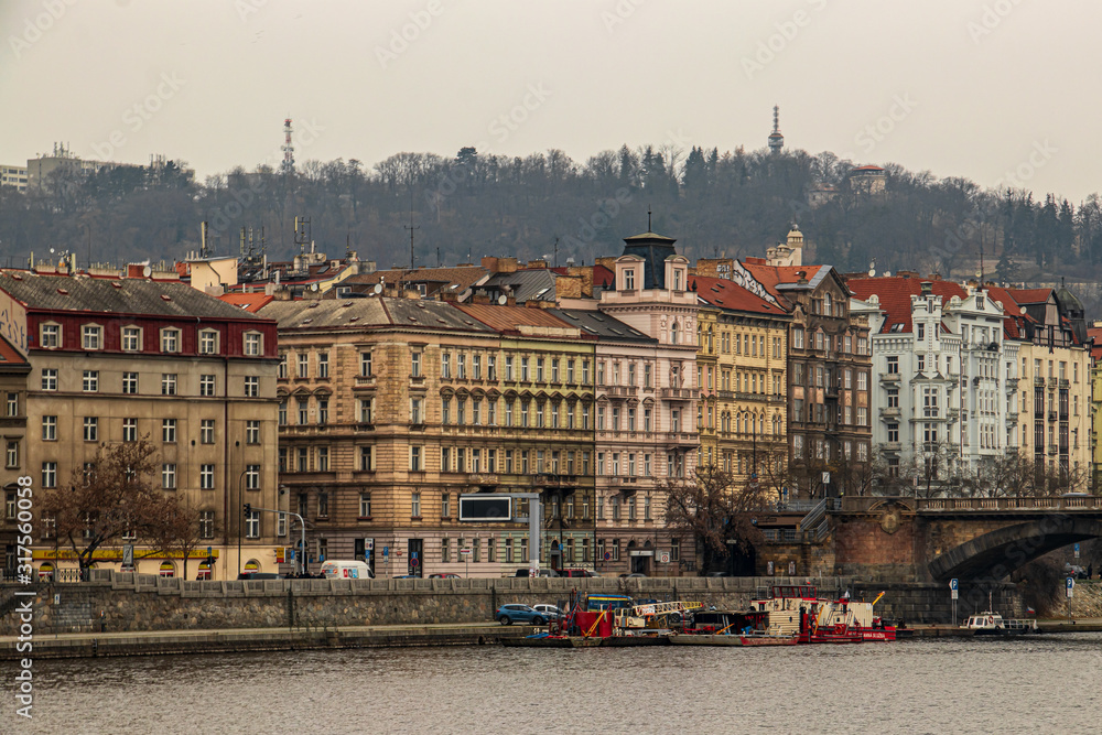 Old buildings in city Prague with river Vltava
