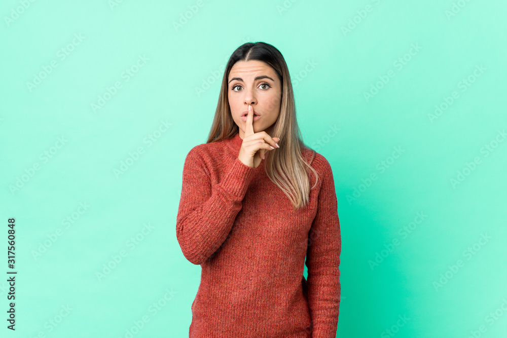 Young caucasian woman isolated keeping a secret or asking for silence. Young caucasian woman isolated keeping a secret or asking for silence.