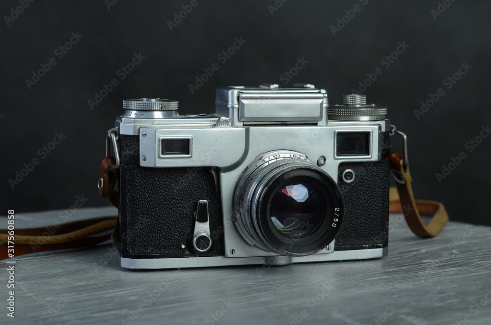 The old camera. Vintage camera. Vintage, metal camera on a black background