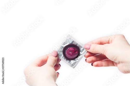 color condom in female hand isolated on a white background