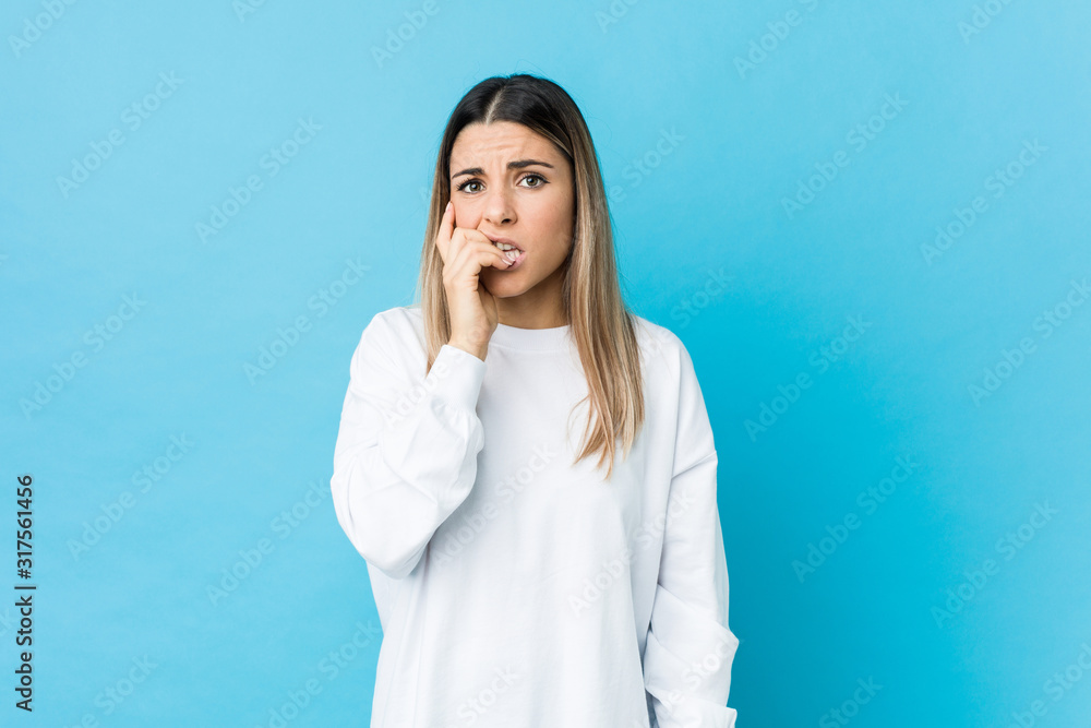 Young caucasian woman isolated biting fingernails, nervous and very anxious. Young caucasian woman isolated biting fingernails, nervous and very anxious.