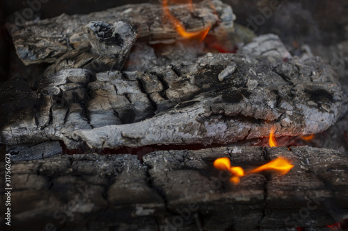 Burning firewood in a rusty barbecue