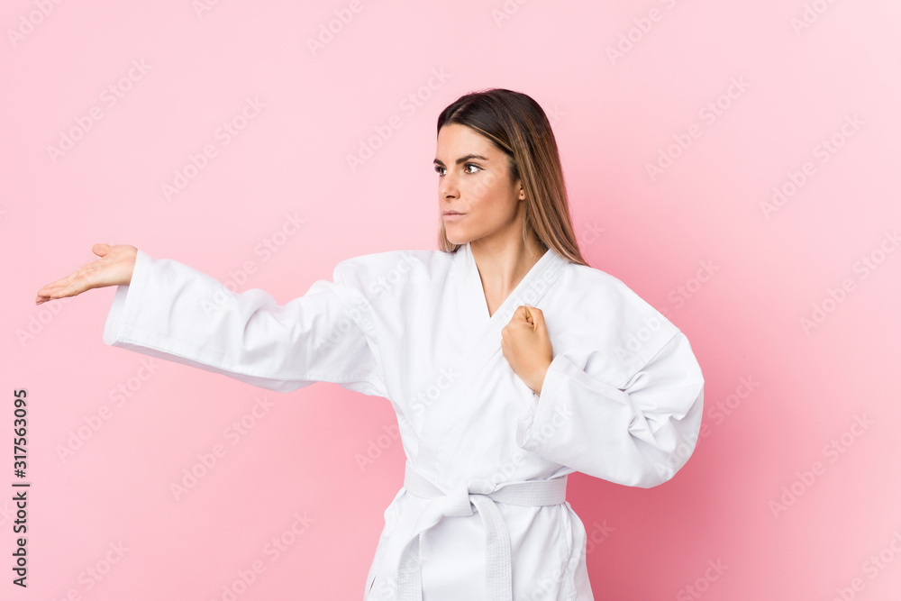 Young caucasian karate woman isolated Young caucasian karate woman isolated